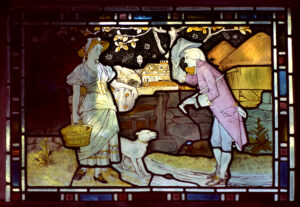 stained glass pastoral image of gentleman greeting lady with baskets and dog