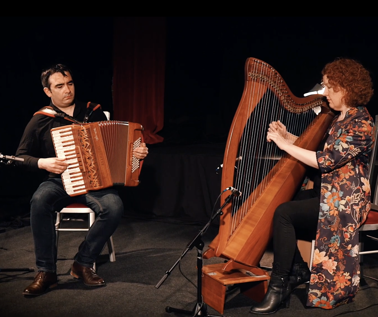 Tríona Marshall playing harp & Martin Tourish playing accordion in black background